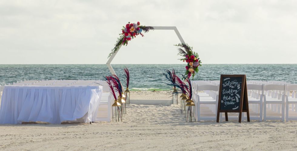 A Table With Flowers On It On A Beach
