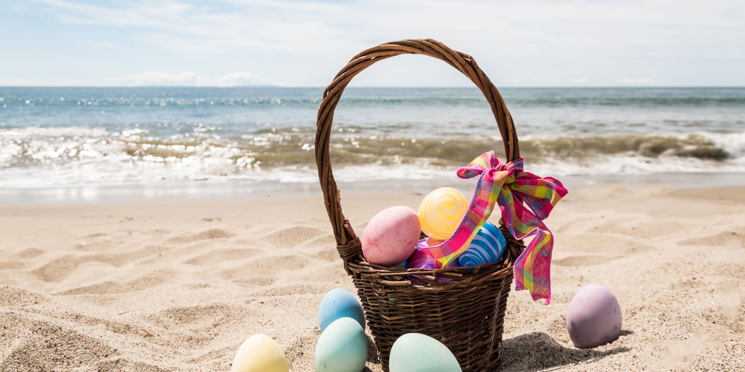 A Basket Of Eggs On A Beach
