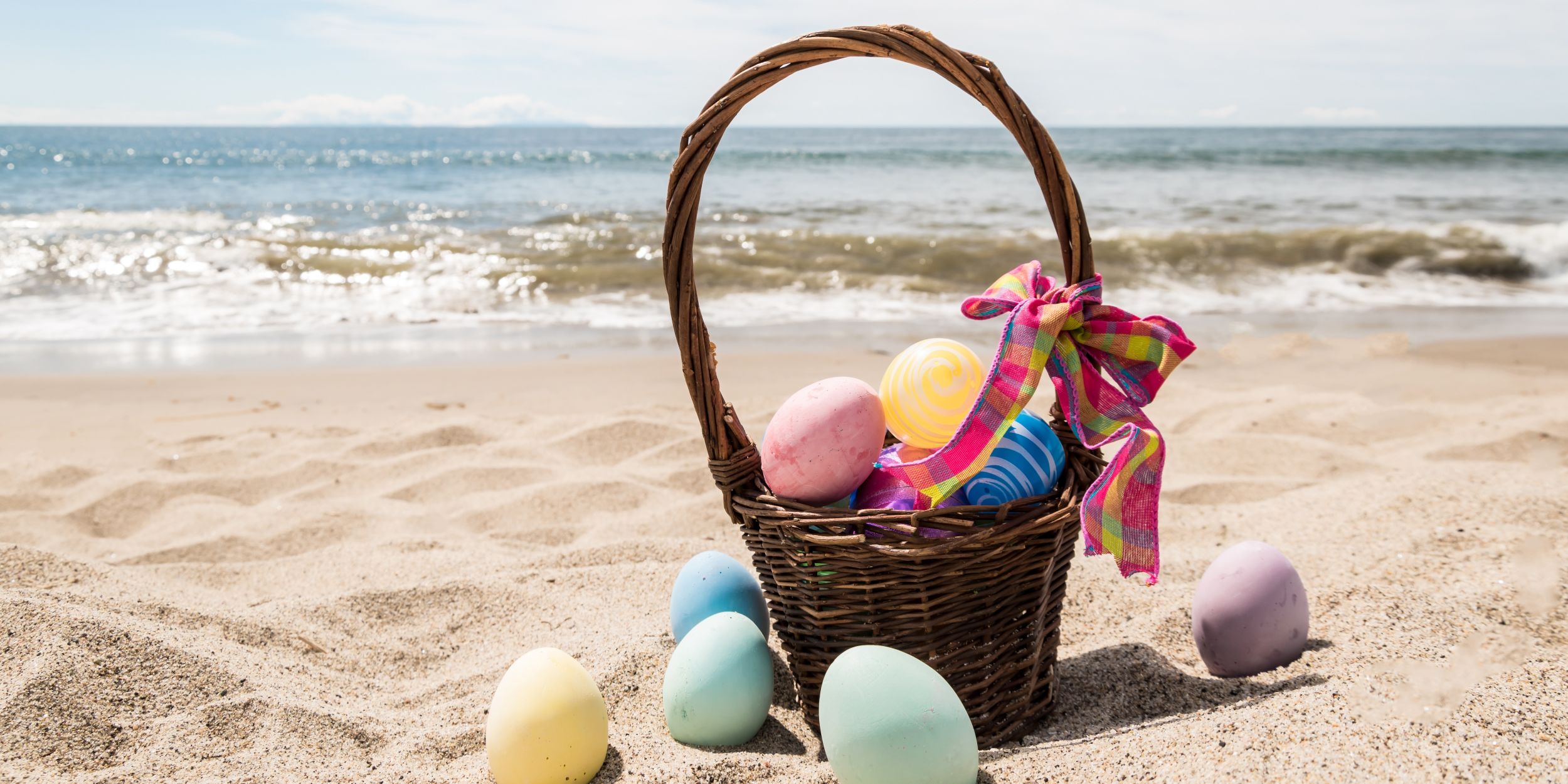 A Basket Of Eggs On A Beach